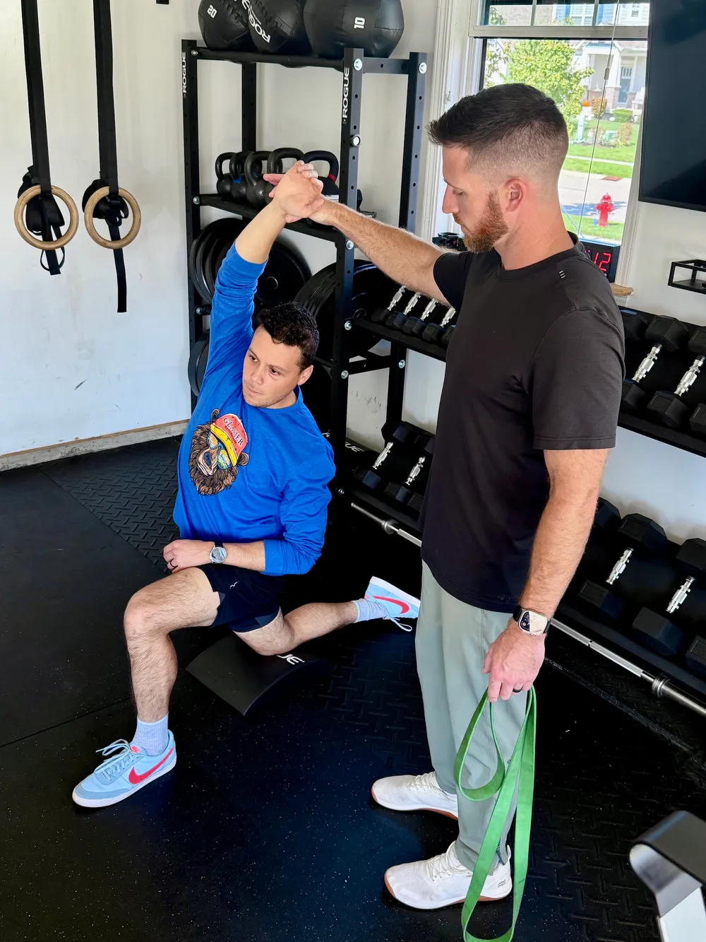 Ryan Summitt guiding a patient through a half-kneeling hip flexor stretch