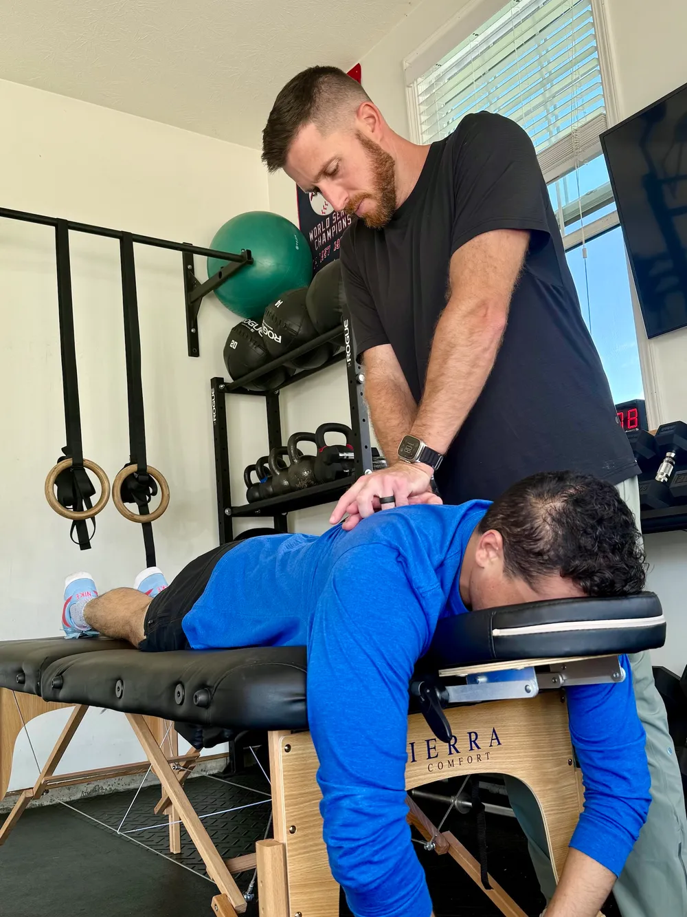 Ryan Summitt performing manual therapy on a patient’s upper back